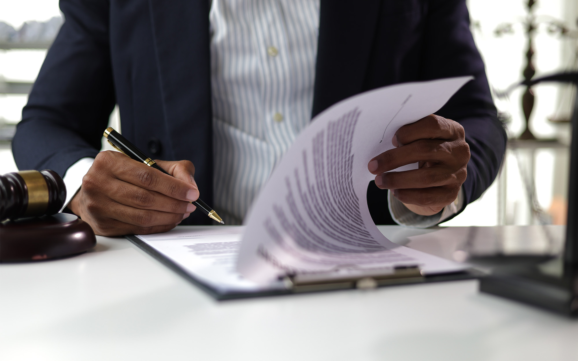 Lawyer Reading Legal Documents And Preparing To Sign A Contract