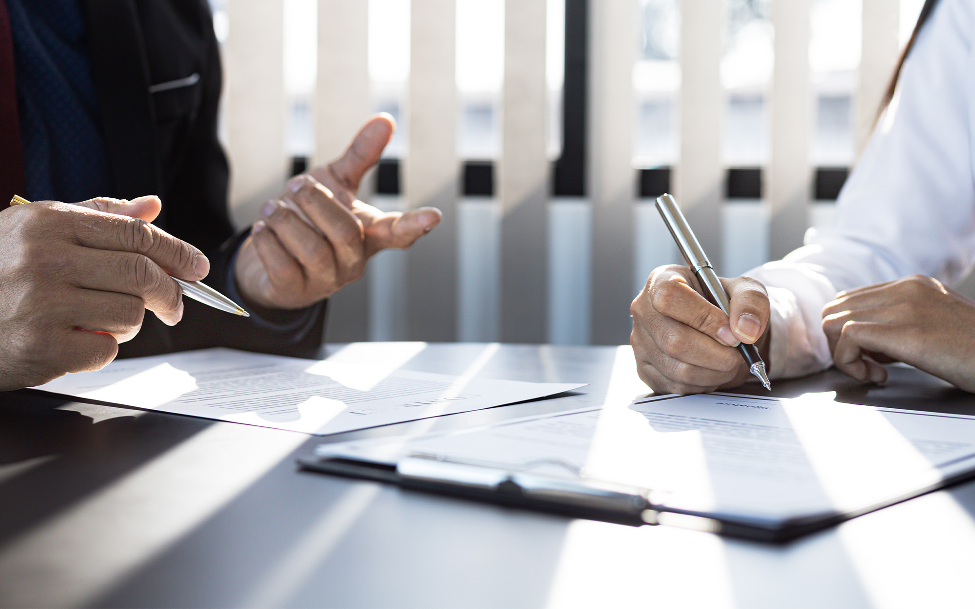 The Home Insurance Salesman And The Customer Are Signing An Insurance Agreement