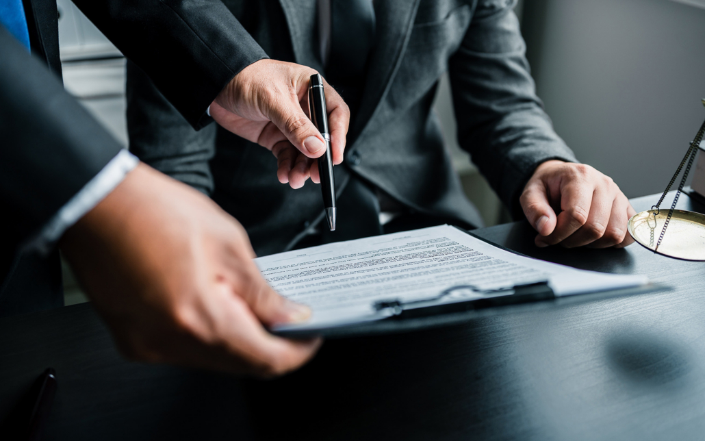 Close Up Of Businessmen Or Lawyers Discussing Contract Or Business Agreement At Law Firm Office